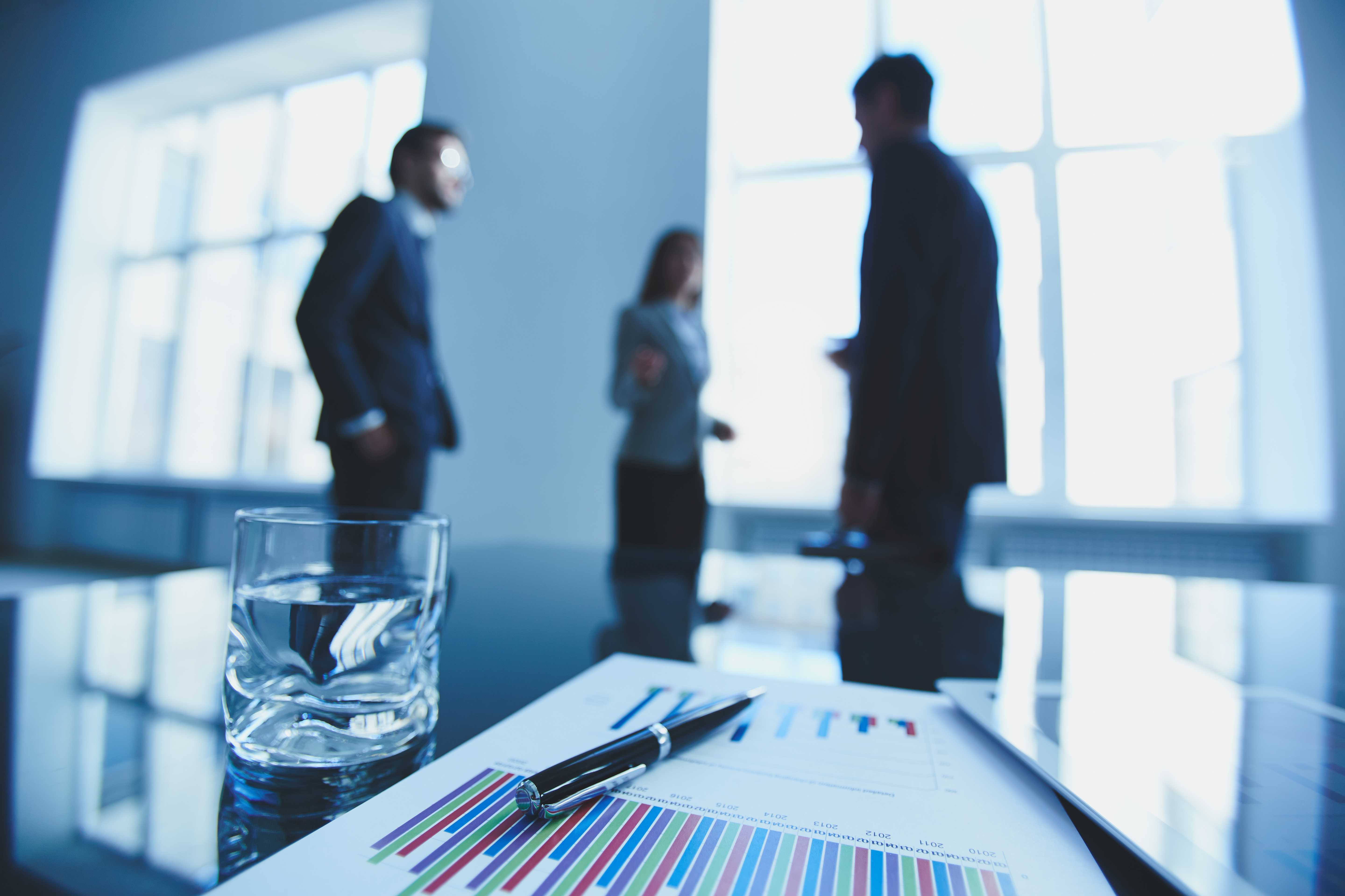 documents-with-charts-glass-water-desk.jpg