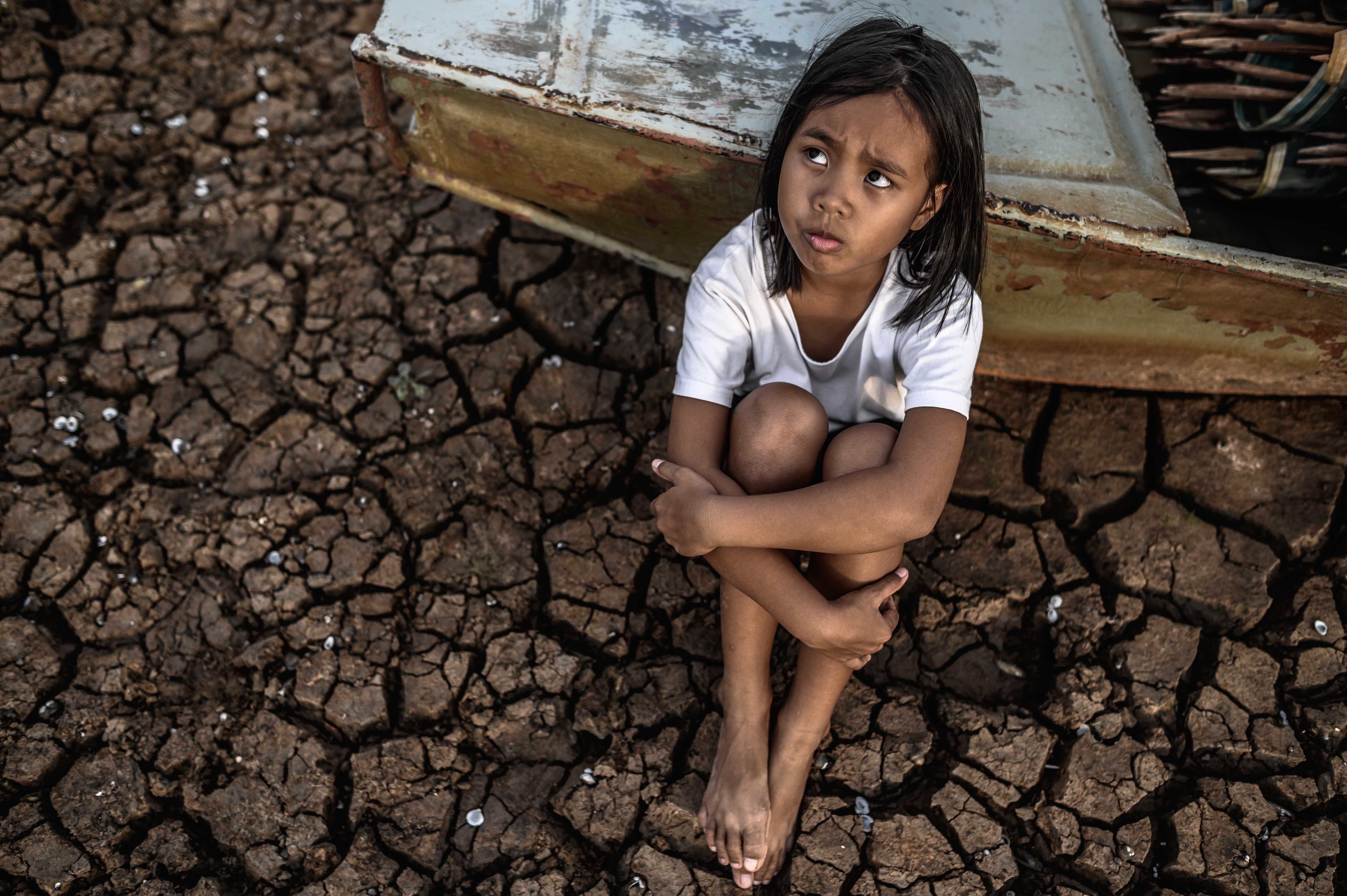 hugging-their-knees-looking-sky-dry-soil-there-are-fishing-boats-global-warming.jpg