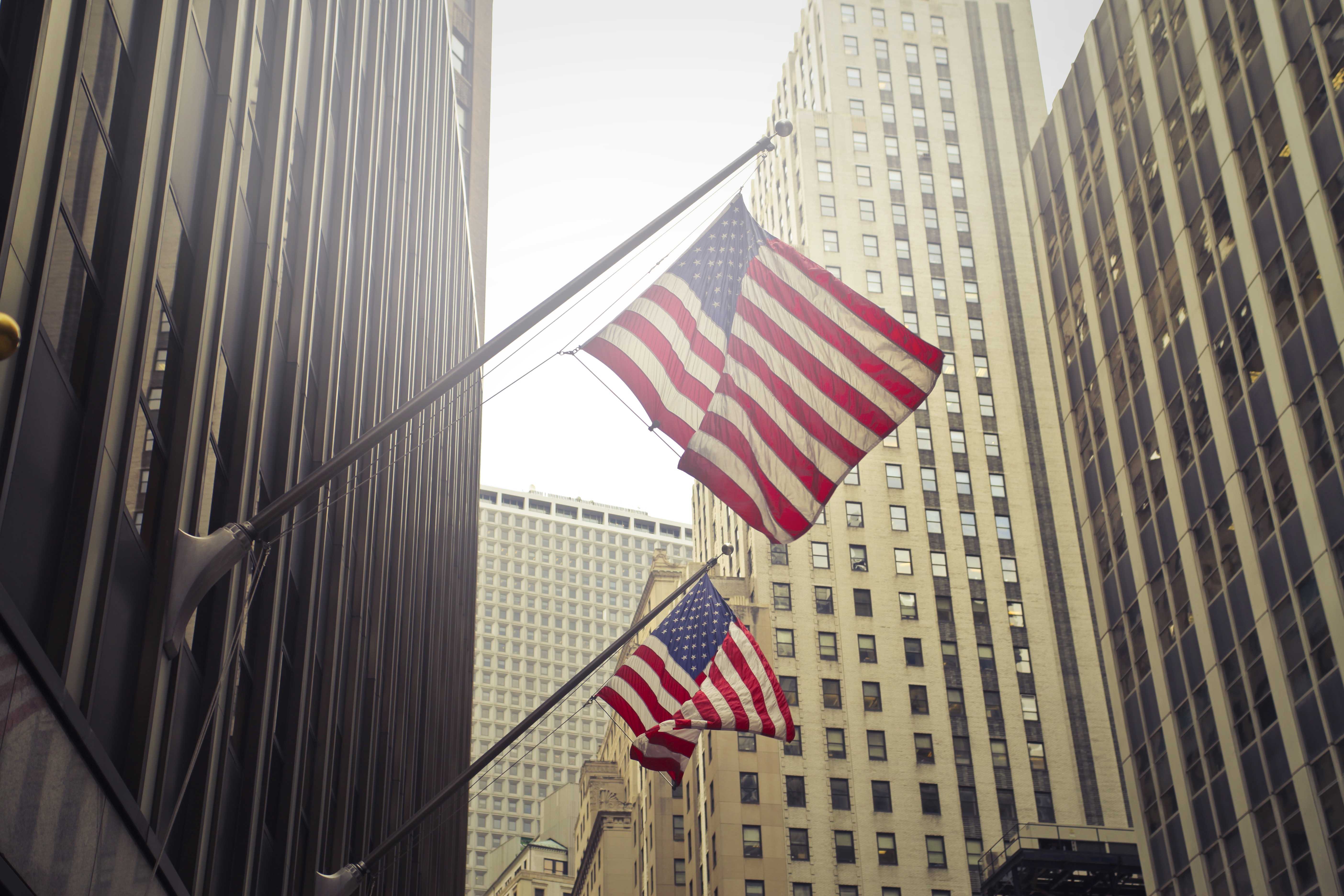 shot-two-american-us-flags-high-rise-building.jpg