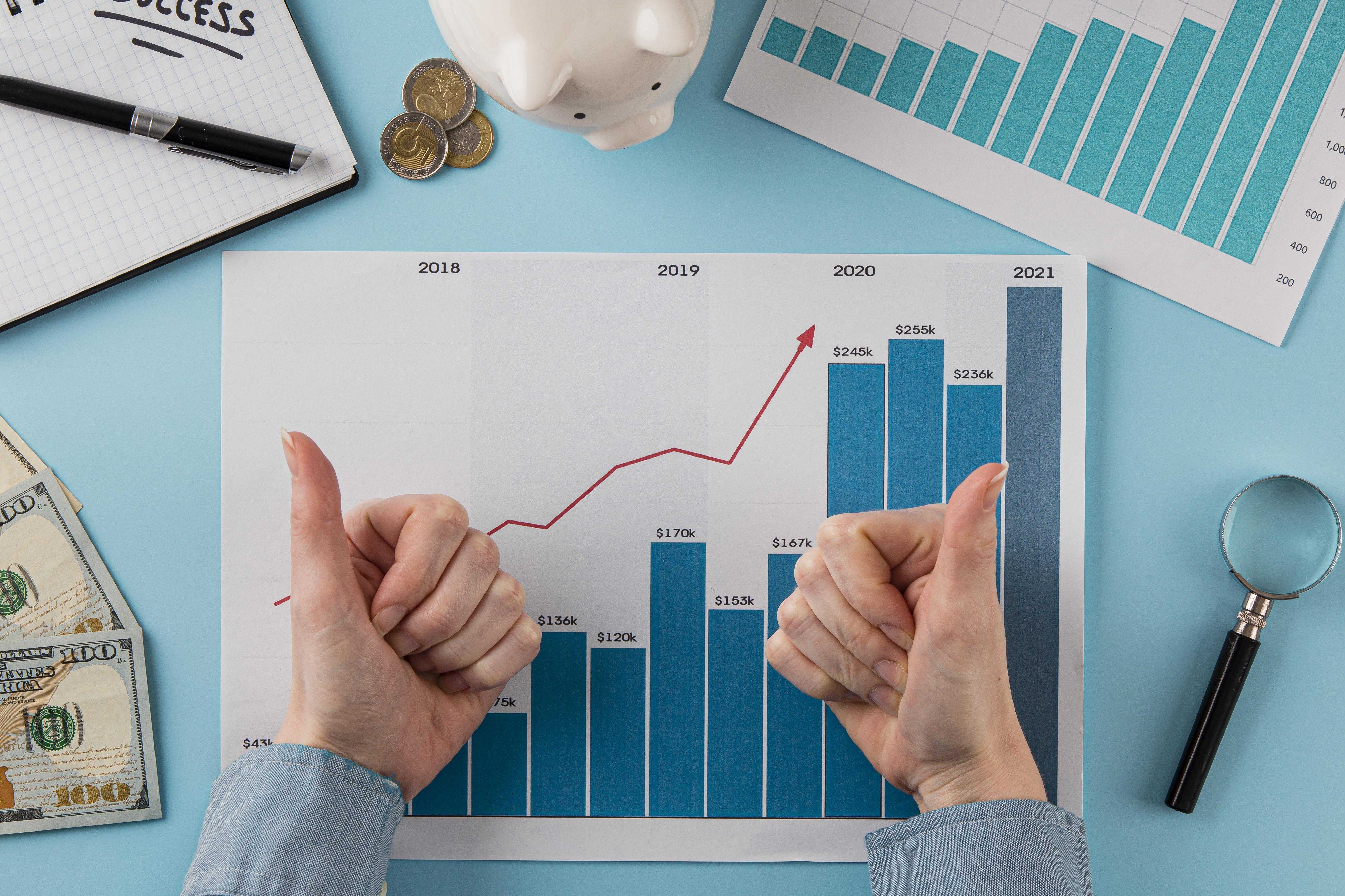 top-view-business-items-with-growth-chart-hands-giving-thumbs-up.jpg